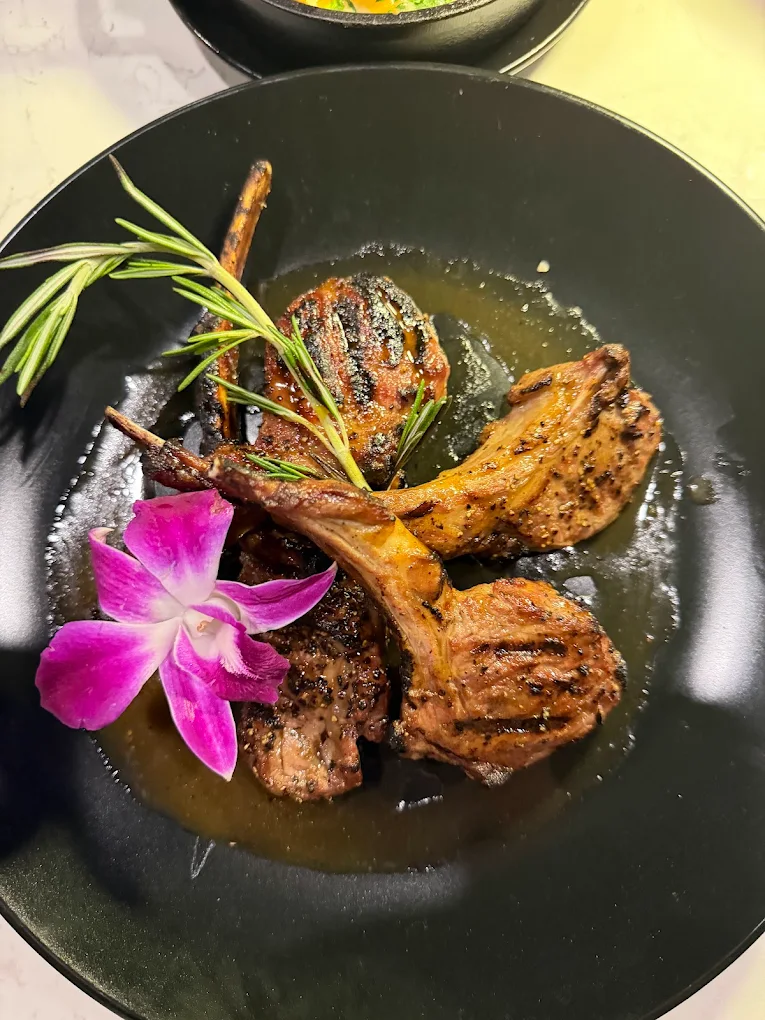 Grilled lamb chops with rosemary and orchid garnish