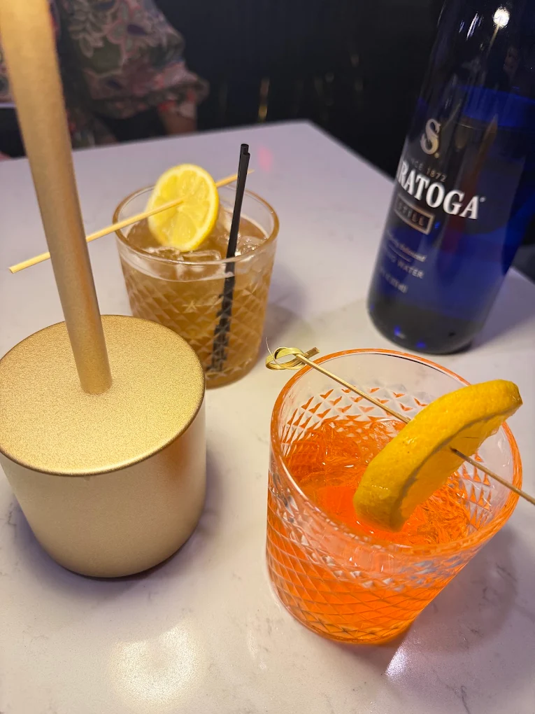 Two citrus cocktails on a marble table